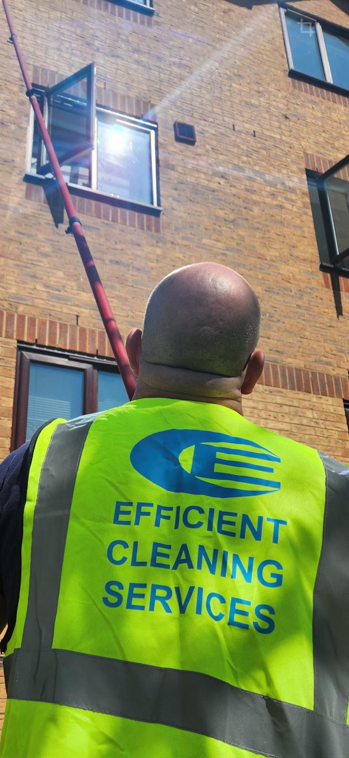 Efficient Cleaning Services operative window cleaning with a water-fed pole in Barnes, SW13